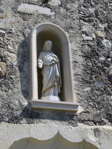 Détail de la statue Sacré Coeur de Jésus au-dessus de la porte du château